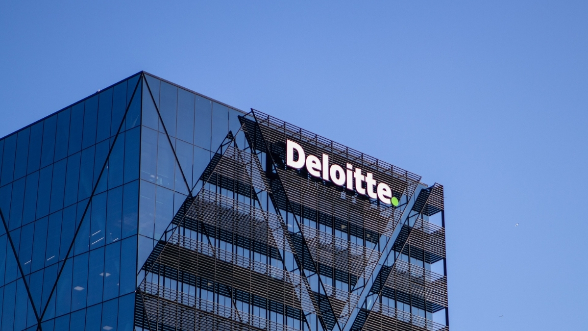 Modernes Bürogebäude mit dem Schriftzug „Deloitte“ an der Fassade