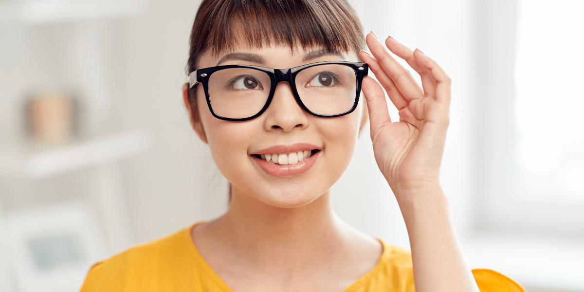 Eine junge Frau trägt eine schwarze Brille.